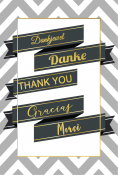 Kaart met grijze zigzagachtergrond, zwarte banners met goud omrand. Tekst: "Dankjewel", "Danke", "THANK YOU", "Gracias", "Merci".